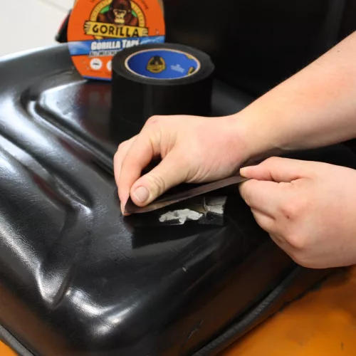 Gorilla All Weather Tape használat közben – extra erős fekete ragasztószalag műanyag felület javításához, kültéri alkalmazásra is alkalmas